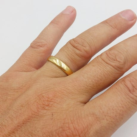 Lot 145 - A 22 carat gold band ring, finger size R, a